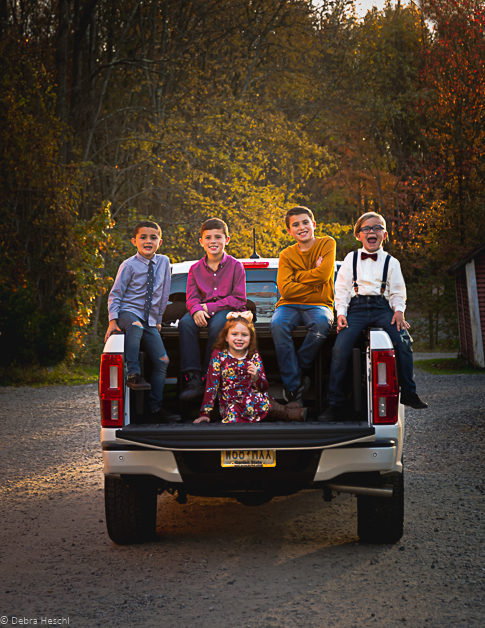 Five kids sitting on the back of a truck-Debra Heschl Photography