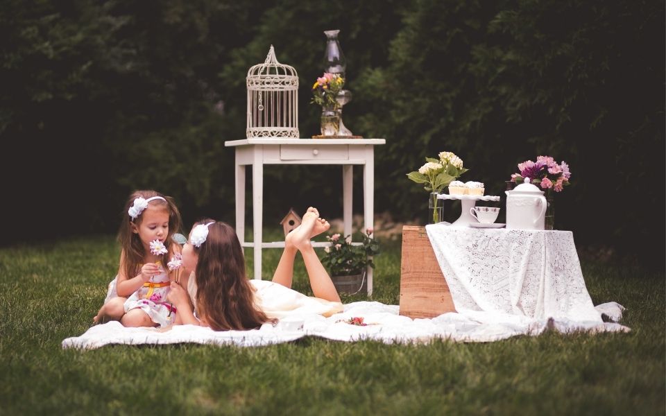 sisters having a tea party in their backyard-Debra Heschl Photography