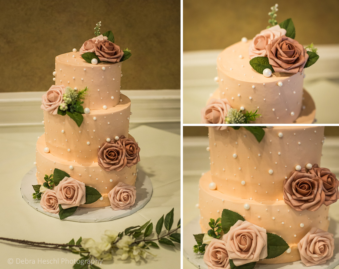 Three-tier blush wedding cake decorated with dusty rose sugar flowers and pearl detailing at Cutillo's Restaurant.