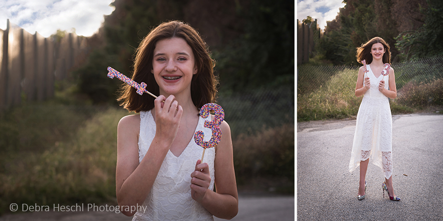 13-year-old girl in white lace dress holding sprinkle number wands for her 13th birthday photo session in Bridgeport, PA.