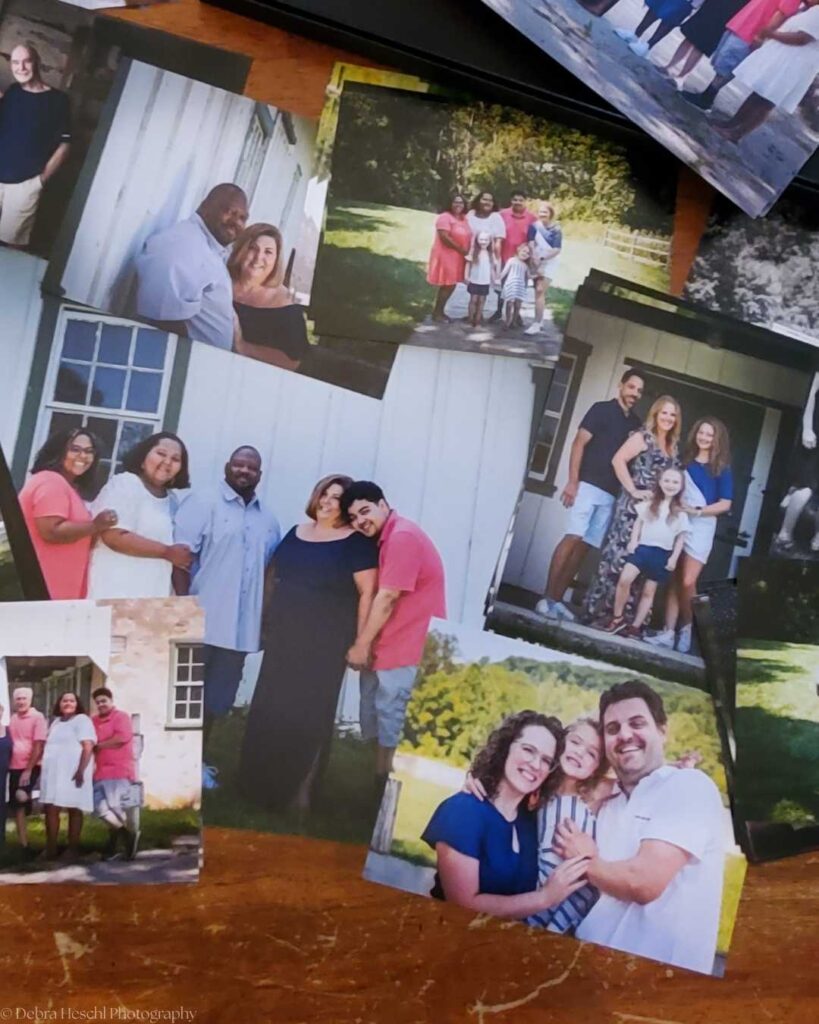 Collection of printed family photos laid out on table showing preserved memories