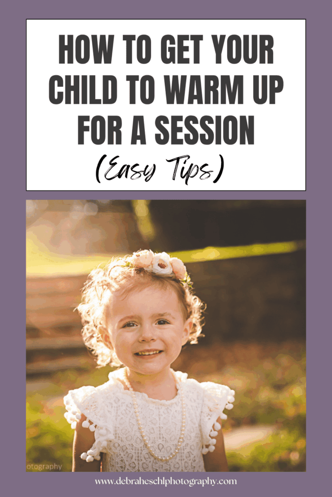 A smiling young child with curly hair and a floral headband stands in sunlight, wearing a frilly white dress. Text above reads 'How to get your child to warm up for a session (Easy Tips)' on a purple background.