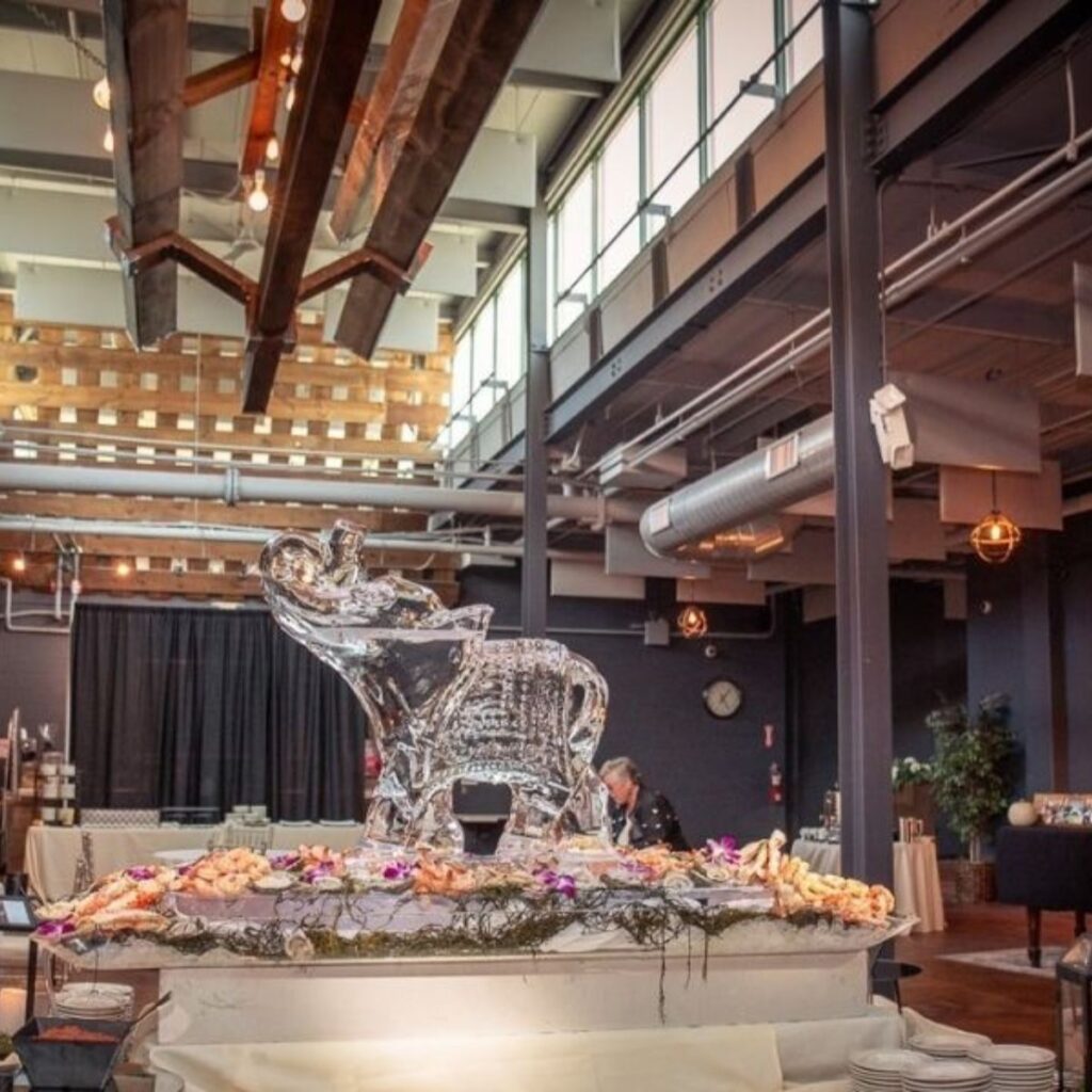 Elegant Pennsylvania wedding venue featuring a decorative ice sculpture display, warm lighting, and modern industrial event space details.