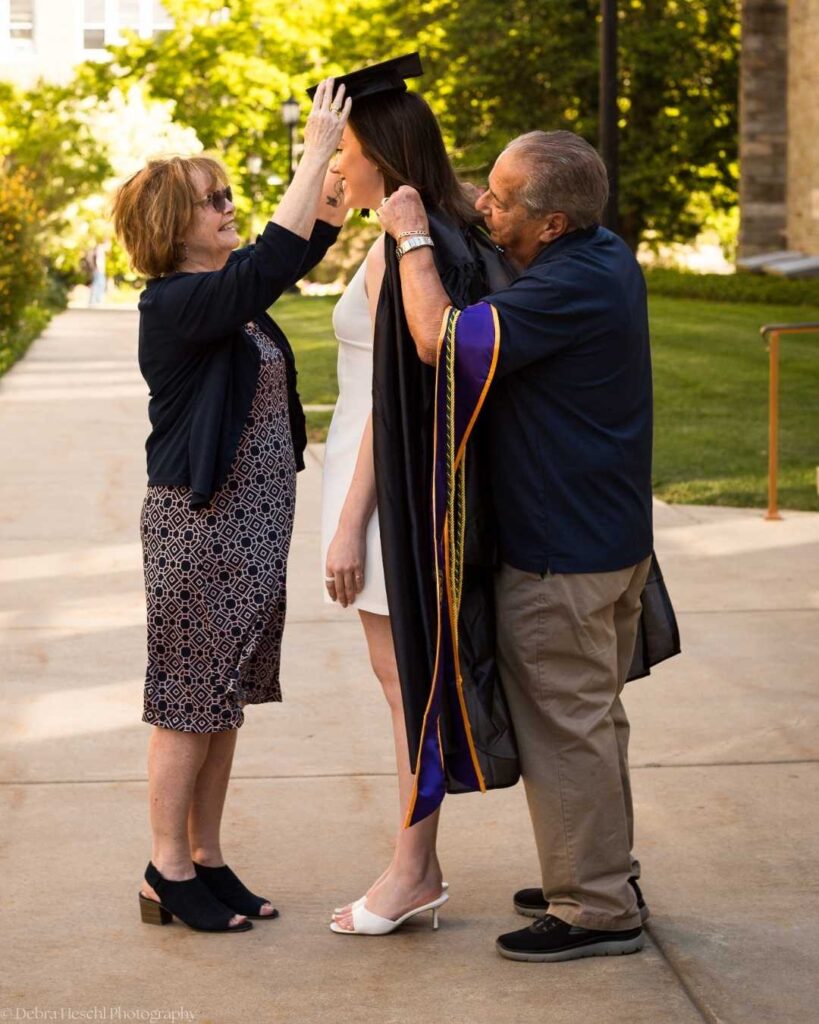 Grandparents helping place the graduation cap on Leah's head during her West Chester University graduation celebration