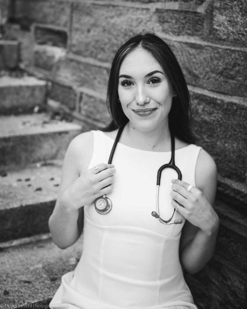 Black and white close-up portrait of Leah holding her stethoscope, celebrating her Respiratory Therapy degree from West Chester University.