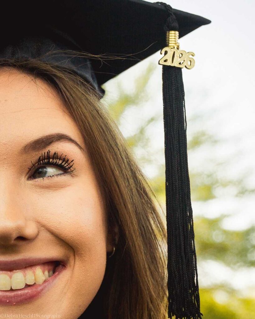 Close-up of Leah smiling with her 2026 graduation tassel, captured by Debra Heschl Photography at West Chester University