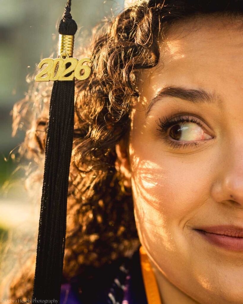 Close-up of West Chester University 2026 graduation tassel and graduate's portrait in golden light.