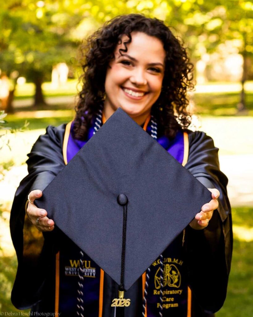 Miranda holding West Chester University Respiratory Care Program graduation cap with 2026 tassel.