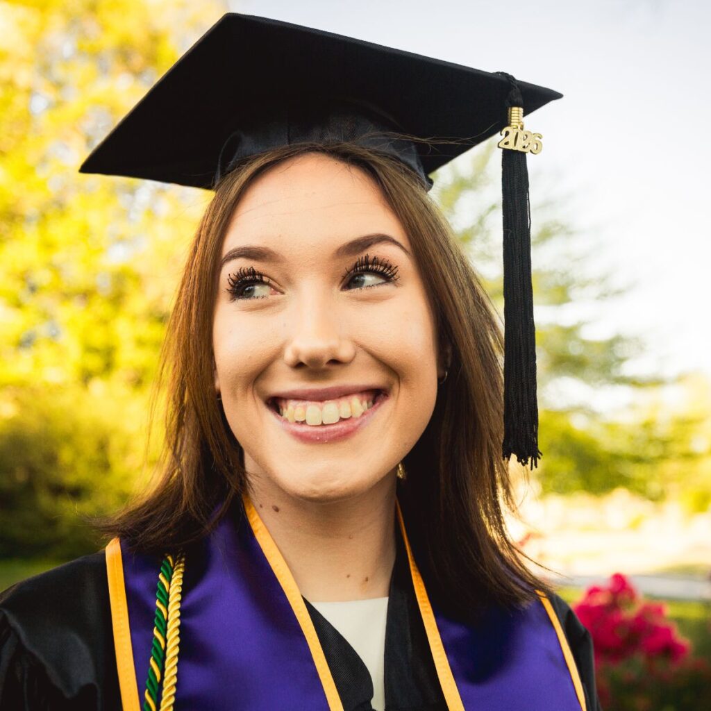 Joyful close-up portrait of Respiratory Therapy graduate Leah in cap and gown at her West Chester University graduation session.