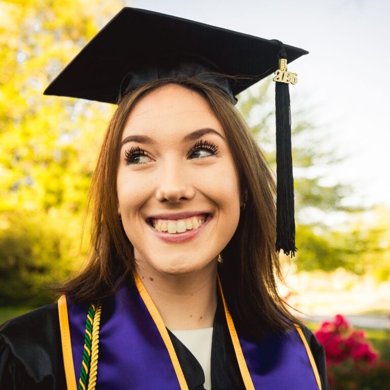 Joyful close-up portrait of Respiratory Therapy graduate Leah in cap and gown at her West Chester University graduation session.