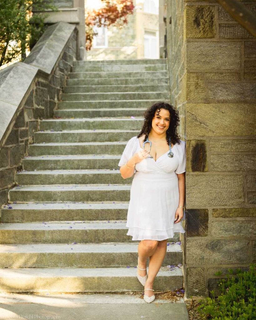 West Chester University Respiratory Therapy graduate poses on stone staircase with stethoscope by Debra Heschl Photography.